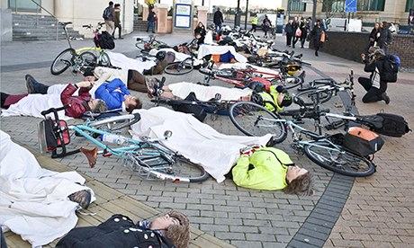 Cyclists lie down on the pavement at Vauxhall Bridge to protest about road safety.